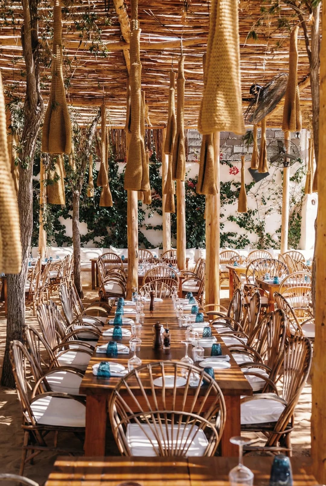 Mediterranean restaurant terrace overlooking Lalla Takerkoust lake at sunset