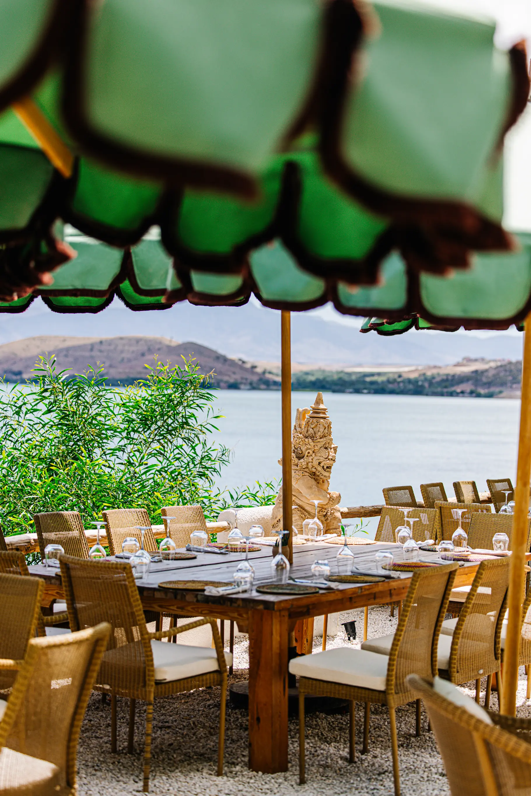 Luxurious boho rooftop seating area offering panoramic views of the Agafay desert surroundings